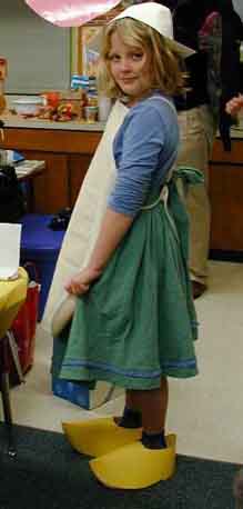 Girl wearing paper Dutch hat and paper wooden shoes